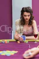 Woman sitting at the table looking at her chips