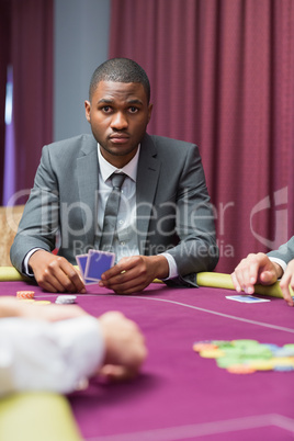 Man looking up from poker