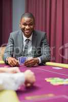 Smiling man looking up from poker