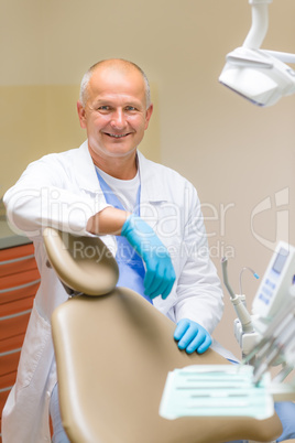 Portrait of mature smiling dental surgeon