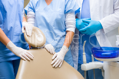 Dental chair surgeons standing around