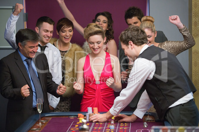 People cheering at roulette table