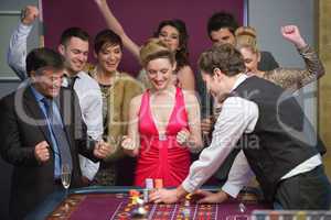 People cheering at roulette table