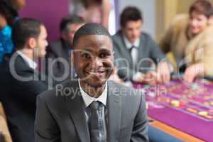 Smiling man sitting at roulette table