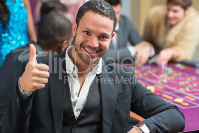 Smiling an thumbs up at roulette table