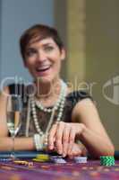 Woman holding chips at roulette table