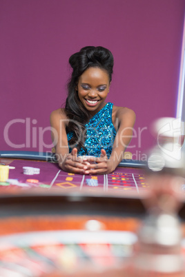 Women grabbing chips at roulette table