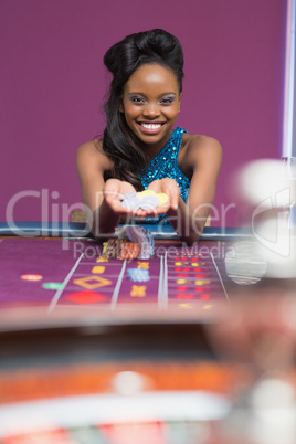 Woman smiling holding up chips