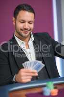 Man holding cards smiling