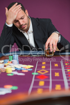 Man looking dejected at roulette table