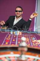 Man in sunglasses at roulette table