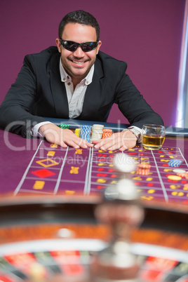 Man grabbing chips wearing sun glasses