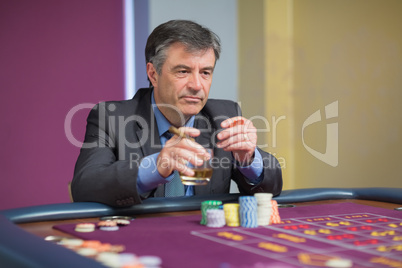 Man looking at the roulette table looking angry