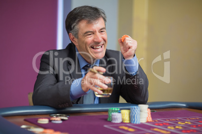 Man winning at roulette table
