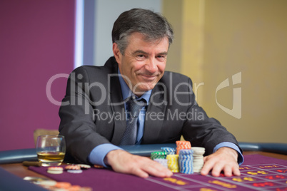 Man smiling and taking his chips