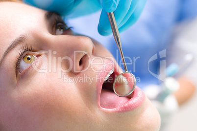 Dental mirror in patient mouth teeth reflection