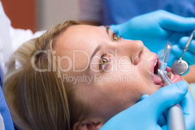 Close-up of dental tools patient open mouth