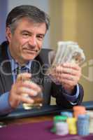 Man holding money and smiling