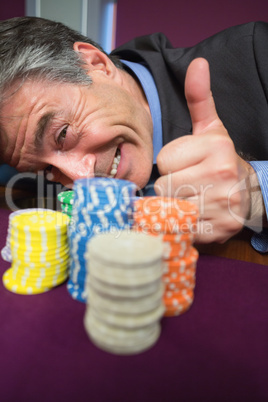 Man leaning on table and giving thumbs up