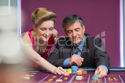 Man and woman placing bets