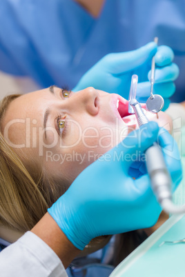 Close-up of dental treatment on female patient