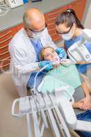 Dentist with nurse check patient teeth