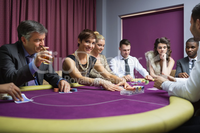 Woman looking up from poker game