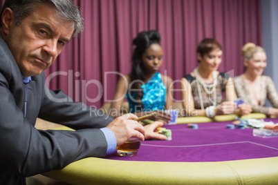 Man with whiskey looking angry at poker game