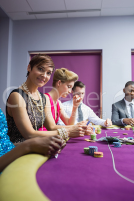 Woman smiling sitting at the poker table