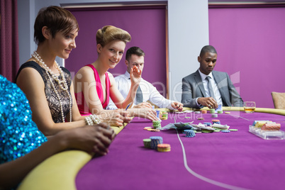 People sitting at the casino table smiling