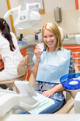 Smiling patient sit dental chair modern surgery