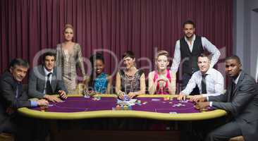 Well-dressed group at poker table