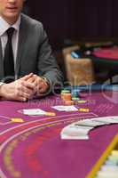 Man sitting at poker table with cards and chips