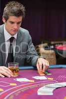 Man looking down at poker table