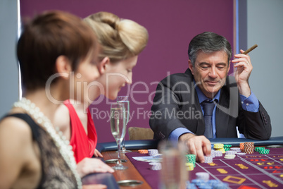 Man with cigar placing bet