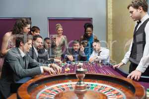 People placing bets on roulette table