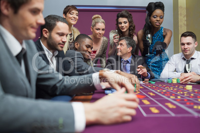 Women watching men play roulette