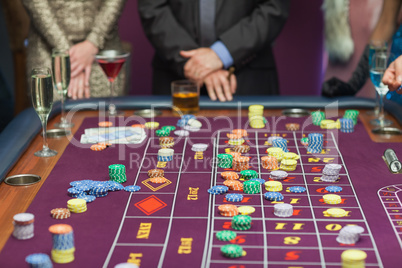 People standing at the table looking at the table