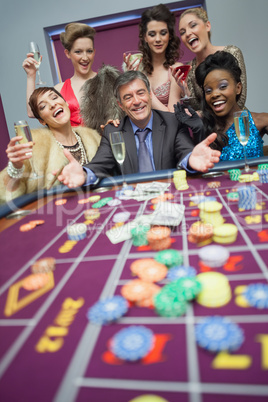 Women celebrating man's success at roulette