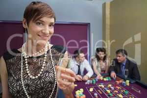 Woman with champagne at roulette table