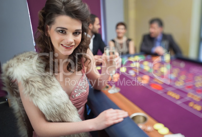 Woman in fur stole at roulette table