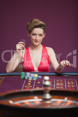 Woman sitting and playing roulette