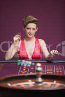 Woman sitting and playing roulette