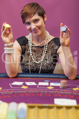 Woman holding chips in her hand in a casino