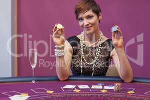 Woman at poker game holding up chips