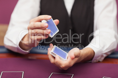 Dealer shuffling deck of cards in a casino
