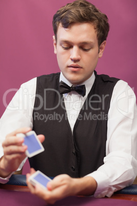 Dealer in a casino shuffling cards