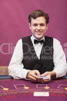 Dealer holding cards in a casino