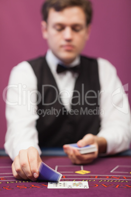 Dealer in a casino distributing cards