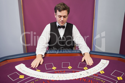 Dealer with fanned out deck of cards